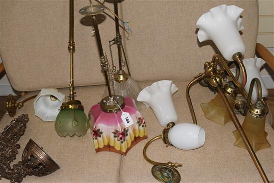 A collection of brass and glass shaded hanging and wall lights